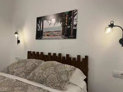 a bedroom with a bed with a picture on the wall at El Bastinazo con Terraza Privada Grupo AC Gestion in Cádiz