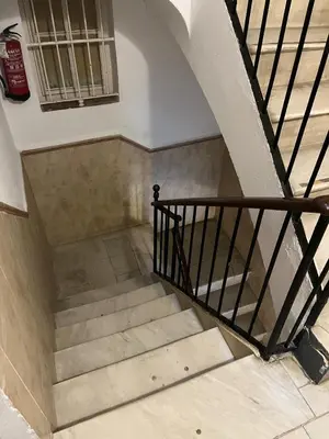 a staircase in a building with a stair case at El Bastinazo con Terraza Privada Grupo AC Gestion in Cádiz