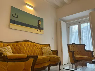 a living room with a yellow couch and two chairs at El Bastinazo con Terraza Privada Grupo AC Gestion in Cádiz