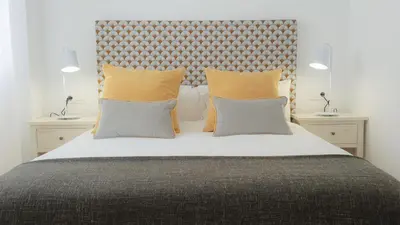 a bedroom with a large bed with two pillows at Casa Velero 32 in Sanlúcar de Barrameda