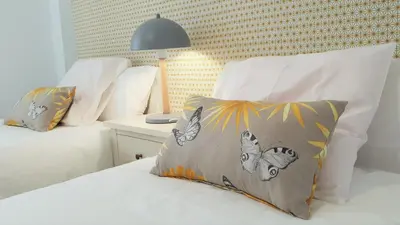 a bedroom with a bed with a pillow and a lamp at Casa Velero 32 in Sanlúcar de Barrameda