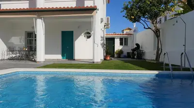 a swimming pool in front of a house at Casa Velero 32 in Sanlúcar de Barrameda