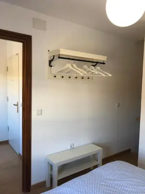 a bedroom with a bed and a table and a light at APARTAMENTOs IGLESIA DE SANTIAGO in Jerez de la Frontera
