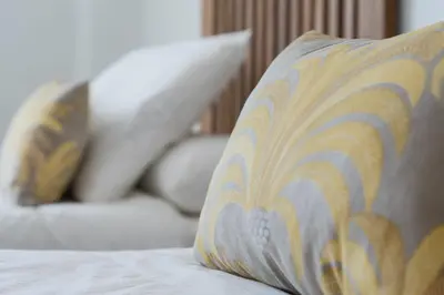 a pillow sitting on top of a bed at Casa de la Jara 10 in Sanlúcar de Barrameda