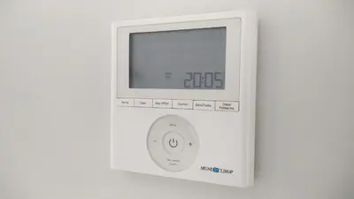 an electronic device with a clock on a wall at Sherryflat Los Cisnes in Jerez de la Frontera