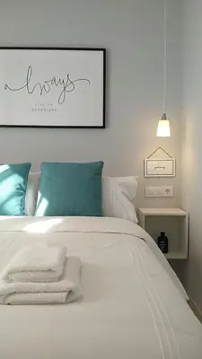 a bedroom with a white bed with towels on it at Sherryflat Los Cisnes in Jerez de la Frontera