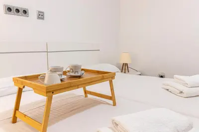 a room with a wooden table with mugs on it at Allo Apartments Valdespino Parking Centro 2 Habitaciones in Jerez de la Frontera
