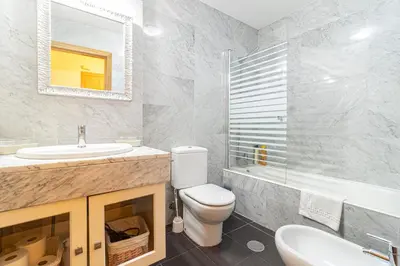 a bathroom with a toilet and a sink and a mirror at Allo Apartments Valdespino Parking Centro 2 Habitaciones in Jerez de la Frontera