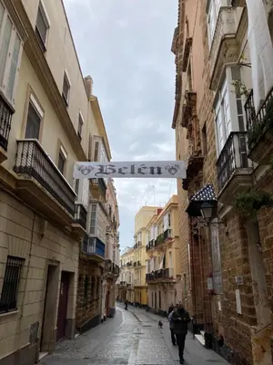 a street sign in the middle of an alley at La Herrería de Sagasta in Cádiz