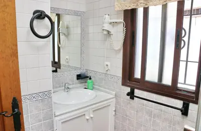 a bathroom with a sink and a mirror at Chalet la Dehesa in Conil de la Frontera