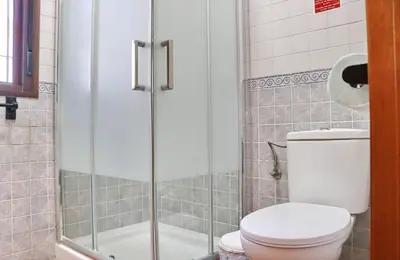 a bathroom with a toilet and a shower at Chalet la Dehesa in Conil de la Frontera