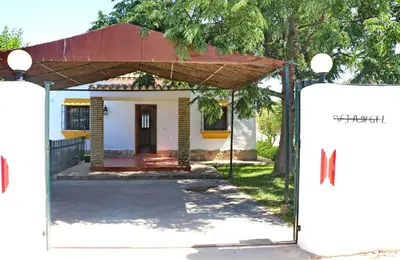 a house with a gate in front of it at Chalet la Dehesa in Conil de la Frontera