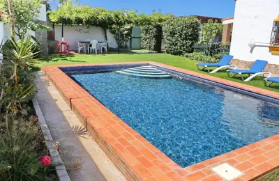 a swimming pool in the backyard of a house at Chalet Dehesa Villa in Conil de la Frontera