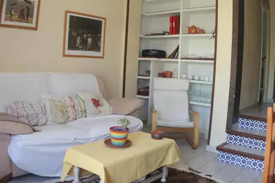 a living room with a couch and a table at Apartamento La Barca in Chiclana de la Frontera