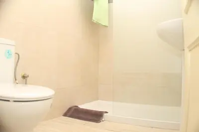 a bathroom with a toilet and a bath tub at Apartamento La Barca in Chiclana de la Frontera