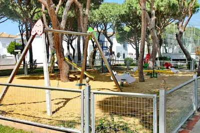 a park with a playground with a swing set at Apartamento La Barca in Chiclana de la Frontera