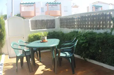 a table and chairs sitting on a patio at Apartamento La Barca in Chiclana de la Frontera