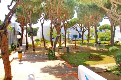 a park with a playground with trees at Apartamento La Barca in Chiclana de la Frontera