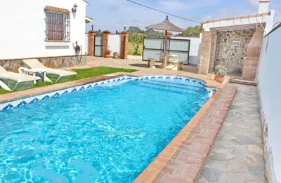 a swimming pool in the backyard of a house at Chalet de la casa Forestal in Conil de la Frontera