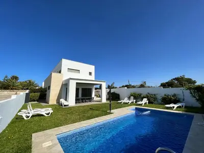 a villa with a swimming pool and a house at Spacious villa in Conil de la Frontera with private pool in Conil de la Frontera