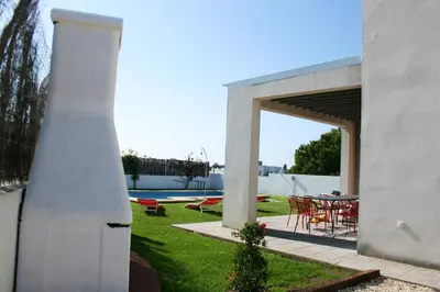 a red couch in a living room with a table at Spacious villa in Conil de la Frontera with private pool in Conil de la Frontera