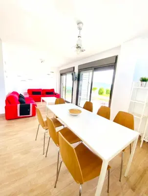 a dining room with a table and a lighthouse picture on the wall at Spacious villa in Conil de la Frontera with private pool in Conil de la Frontera