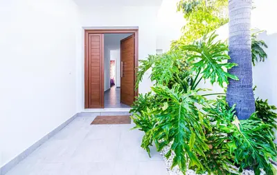a hallway with plants in front of a house at Nice Home In Conil De La Frontera in Conil de la Frontera