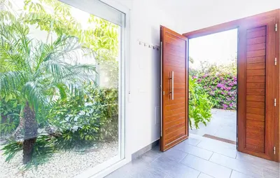 an open door in a house with a garden at Nice Home In Conil De La Frontera in Conil de la Frontera