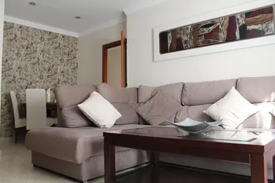 a living room with a couch and a table at APARTAMENTO SAN NICOLAS in Sanlúcar de Barrameda