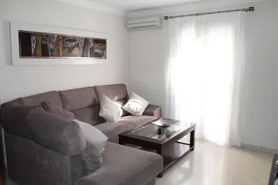 a living room with a couch and a coffee table at APARTAMENTO SAN NICOLAS in Sanlúcar de Barrameda