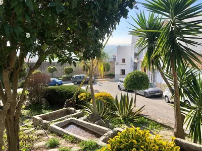 a street with cars parked in a parking lot at Casa La Muralla in Medina Sidonia