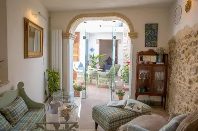 a living room with a table and chairs at Casa La Muralla in Medina Sidonia