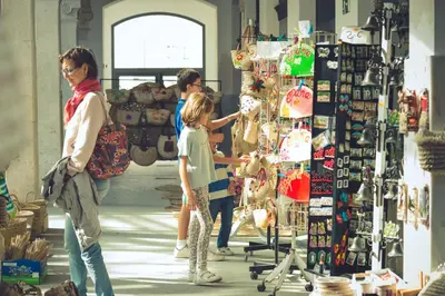 a group of people standing in a store looking at merchandise at Casa La Muralla in Medina Sidonia