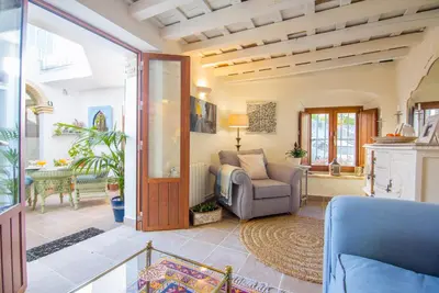 a living room with a couch and a chair at Casa La Muralla in Medina Sidonia