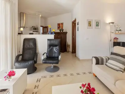 a living room with two chairs and a couch at Costa de la Luz Poolside Villa in Sanlúcar de Barrameda
