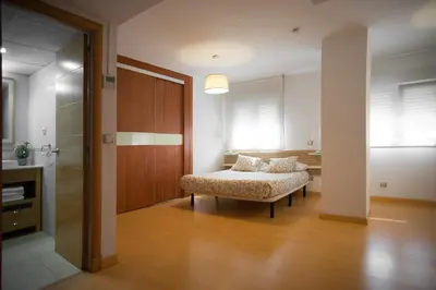 a bedroom with a bed and a door to a room at Santo Tomás B Ha Apartment in Cádiz