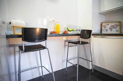 two bar stools sitting at a counter in a kitchen at Santo Tomás B Ha Apartment in Cádiz
