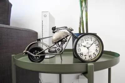 a toy motorcycle on a table next to a clock at Santo Tomás B Ha Apartment in Cádiz
