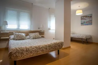 a bedroom with a bed with two pillows on it at Santo Tomás B Ha Apartment in Cádiz