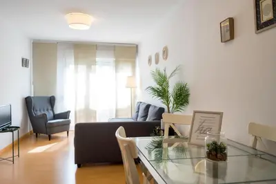 a living room with a couch and a glass table at Santo Tomás B Ha Apartment in Cádiz