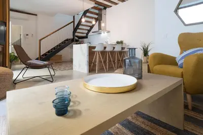 a living room with a table with a plate on it at Atico Gades de la Catedral in Cádiz