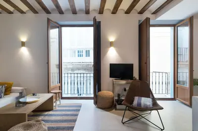 a living room with a couch and a tv at Atico Gades de la Catedral in Cádiz