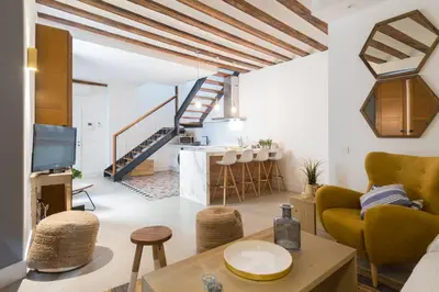 a living room with a couch and a table at Atico Gades de la Catedral in Cádiz