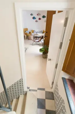 a hallway leading to a living room with a checkered floor at Atico Gades de la Catedral in Cádiz