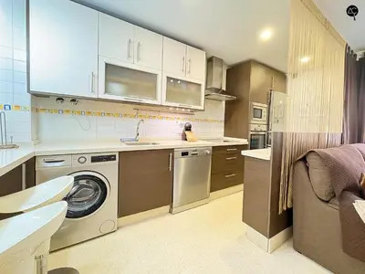 a kitchen with a washing machine and a sink at URBAN BEACH Grupo AC Gestion in Cádiz