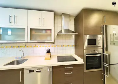 a small kitchen with a sink and a refrigerator at URBAN BEACH Grupo AC Gestion in Cádiz