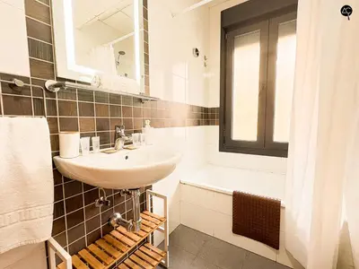 a white bathroom with a sink and a bath tub at URBAN BEACH Grupo AC Gestion in Cádiz
