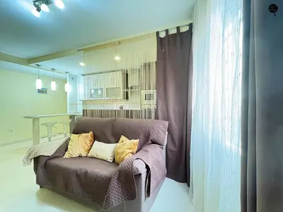 a couch with pillows on it in a living room at URBAN BEACH Grupo AC Gestion in Cádiz