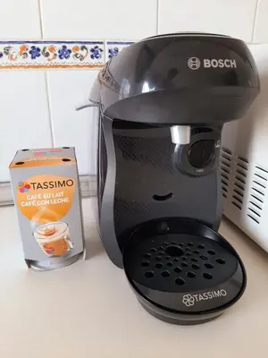 a black coffee maker next to a box on a counter at Apto Playa de Regla, primera linea, Parking, AA y wifi in Chipiona