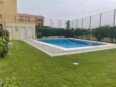 a swimming pool in a yard next to a building at Home Chipiona Cadiz Parking in Chipiona